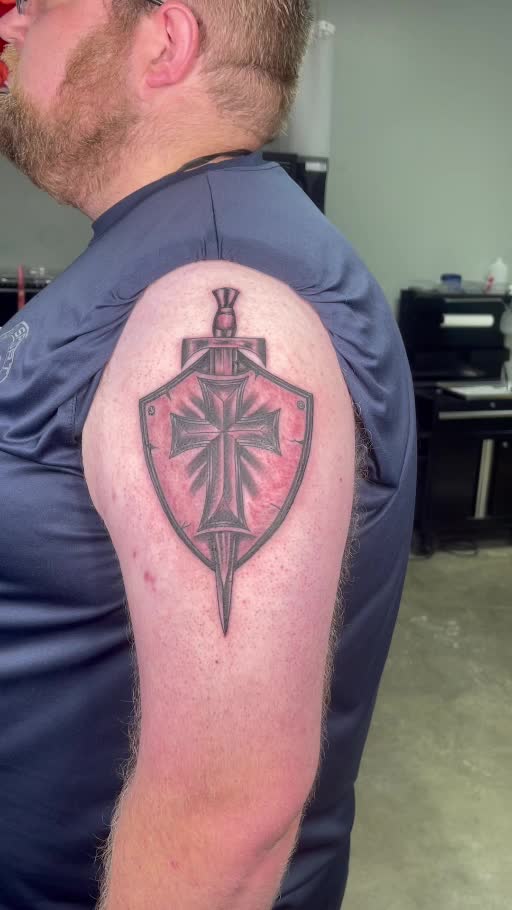 Black and grey shield and sword tattoo
