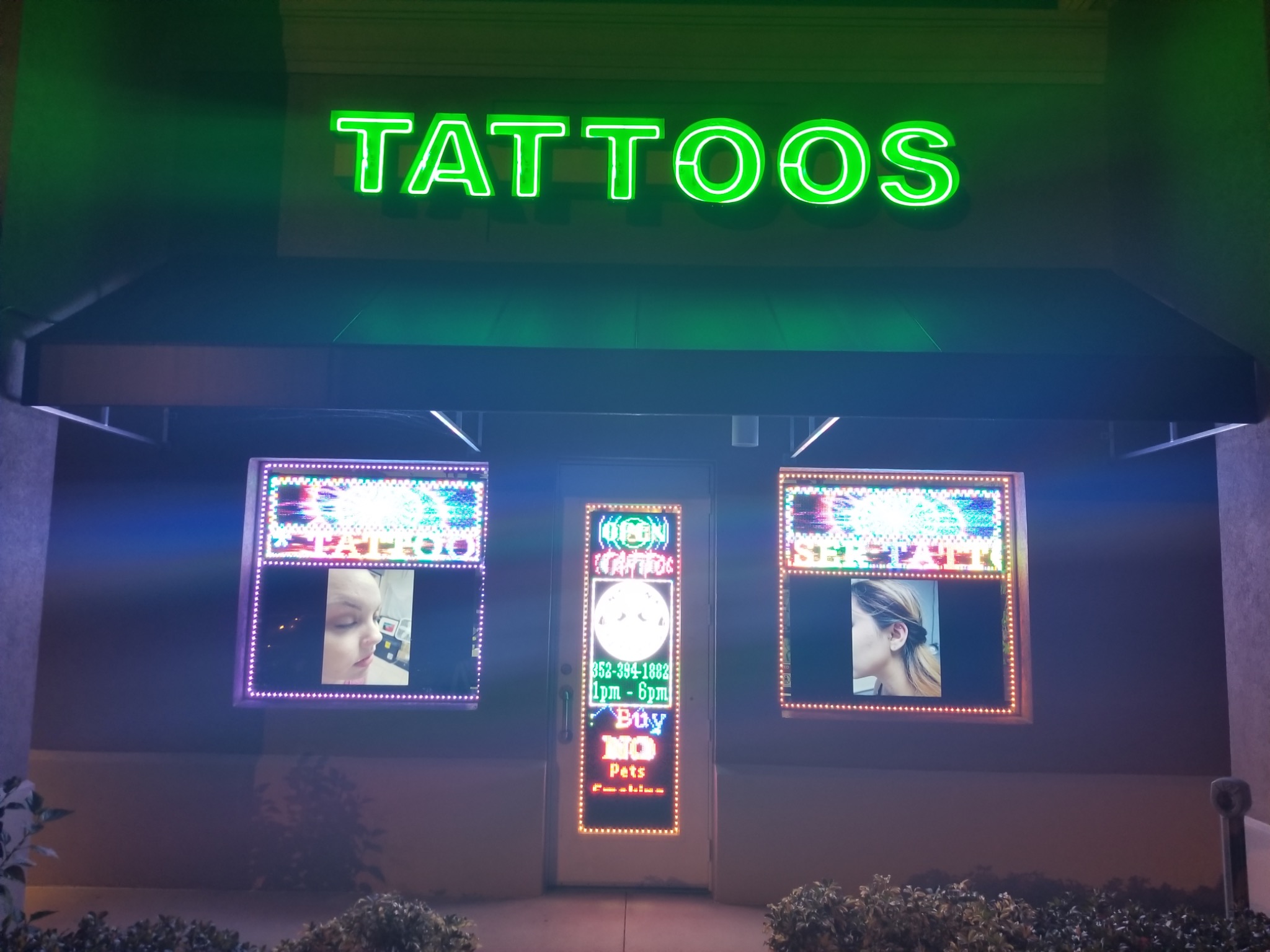 Ink Ink Tattoos storefront illuminated at night